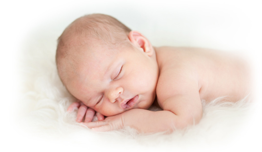 3800650-newborn-baby-girl-sleeping-on-her-stomach